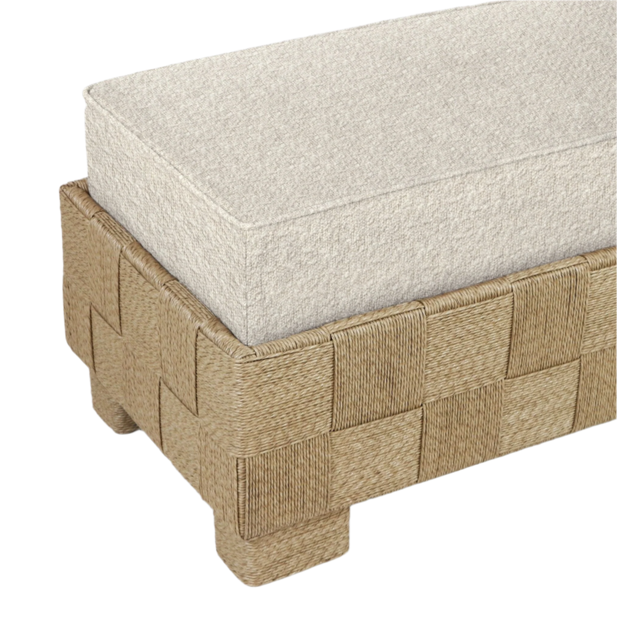 Close-up of a modern end-of-bed bench with a cream boucle fabric cushion resting on a natural seagrass woven base featuring a checkerboard weave and low block feet.