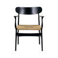 Front view of a modern black solid wood dining chair with a wide curved backrest, slim armrests and a natural woven rope seat.