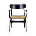 Front view of a modern black solid wood dining chair with a wide curved backrest, slim armrests and a natural woven rope seat.