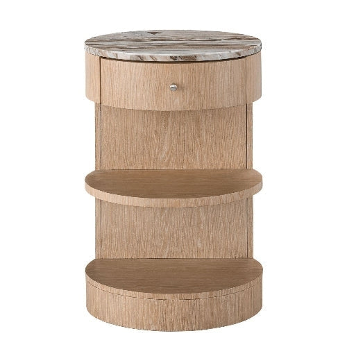 Round marble-top nightstand in natural blonde wood with a curved solid-wood base, one front drawer with a small metal knob, and two open semicircular shelves.