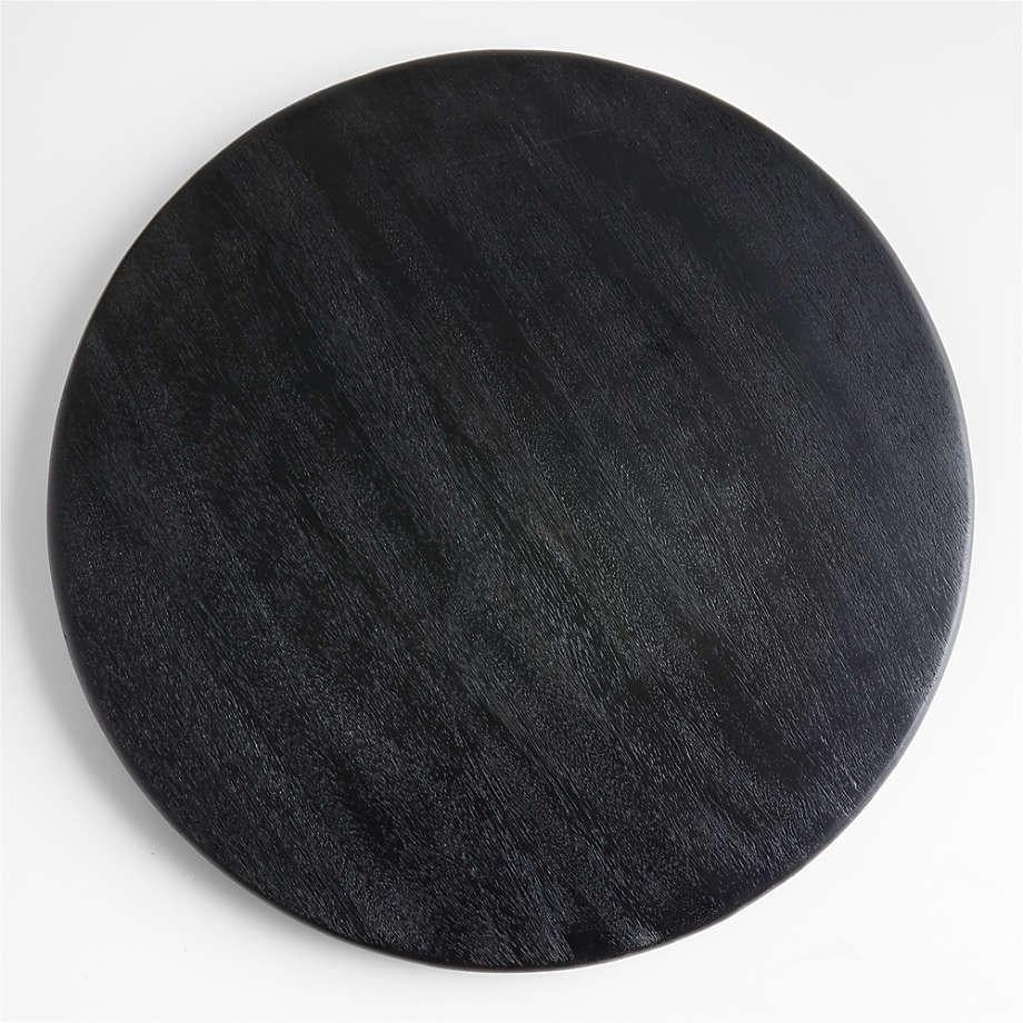 Top-down view of a round black oak butter board showing subtle natural wood grain and a smooth rounded edge on a white background.