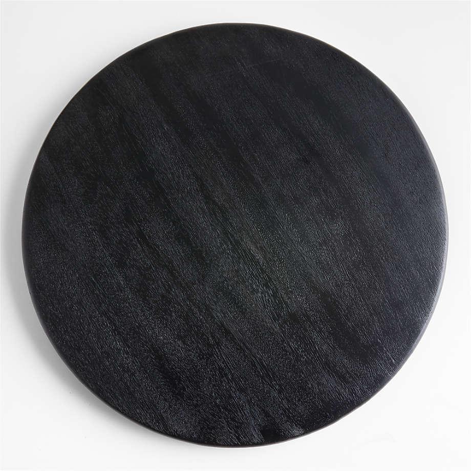 Top-down view of a round black oak butter board showing subtle natural wood grain and a smooth rounded edge on a white background.