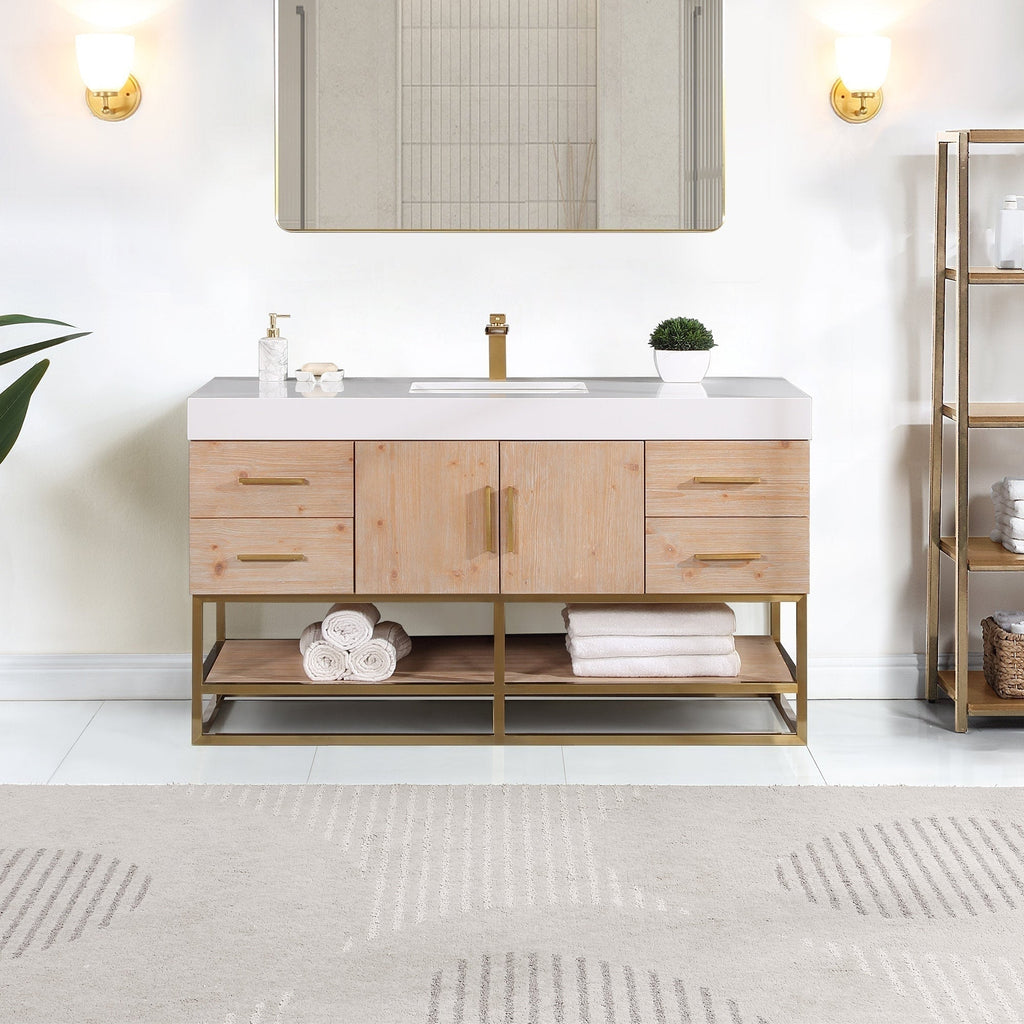 60-inch modern bathroom vanity in light natural wood with a white composite stone countertop, rectangular undermount sink, brass faucet and pulls, and open brass metal shelf holding folded towels.