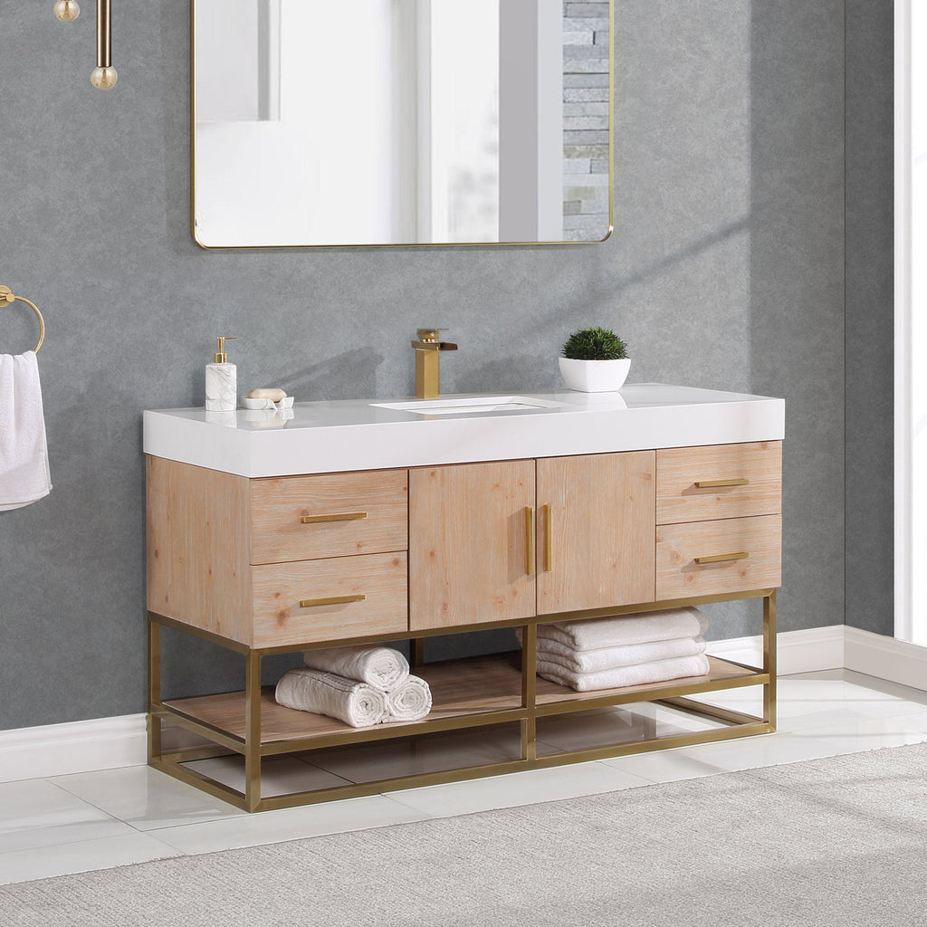 60-inch modern natural wood single-sink bathroom vanity with white composite stone top, rectangular undermount sink and single-hole brass faucet; gold metal base and hardware, open shelf with rolled white towels under a gold mirror.