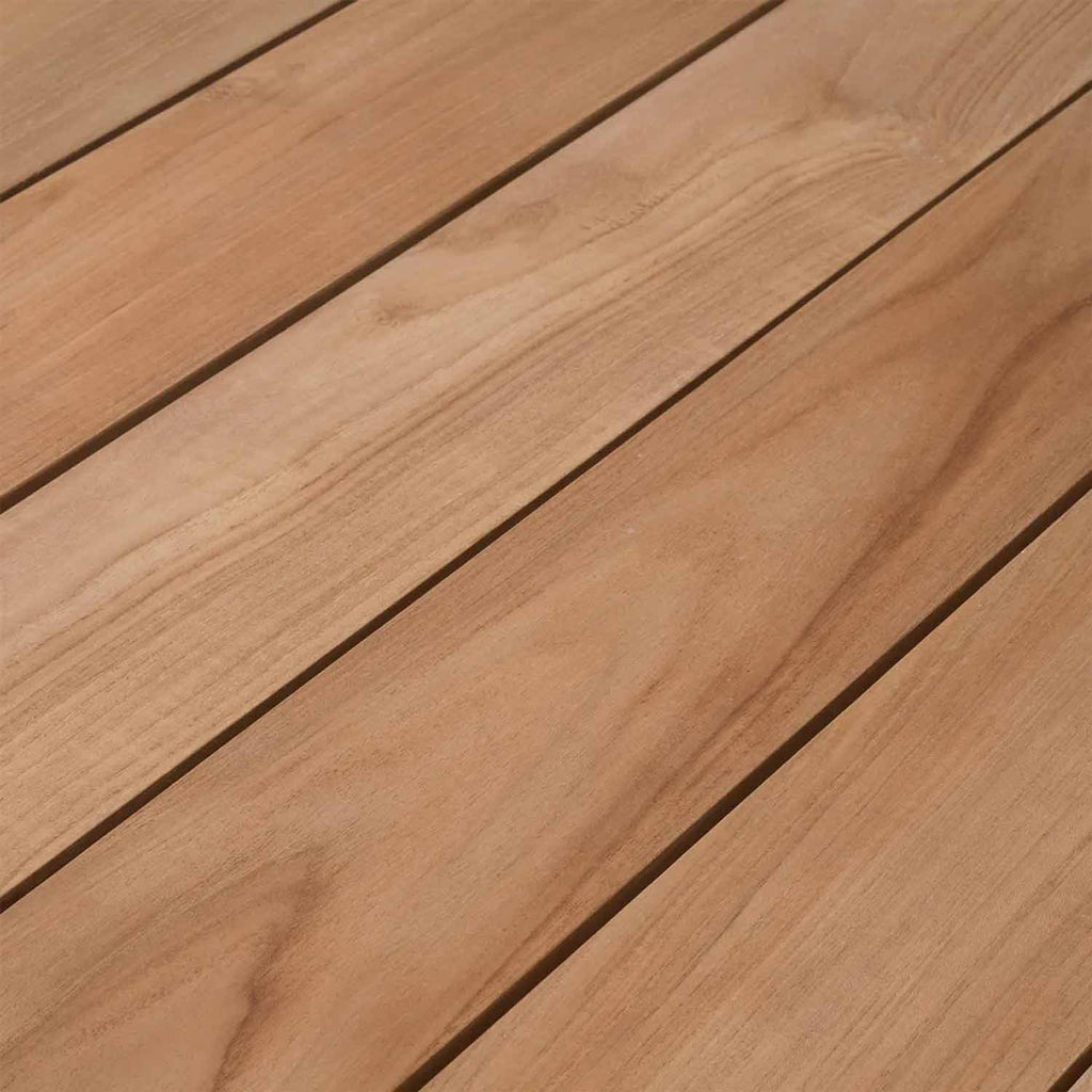 Close-up of natural teak wood slats in warm honey tones, showing wood grain and narrow gaps between planks to highlight the outdoor dining chair's finished seat surface.