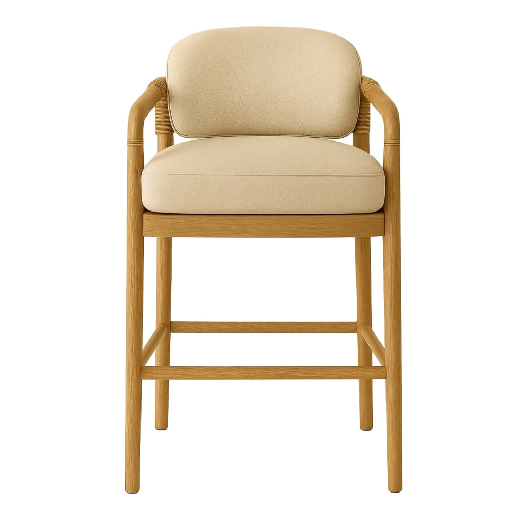 Front view of a teak-framed bar stool with natural beige upholstered seat and back, rope-wrapped arm supports, tapered legs and a built-in footrest in a Scandinavian coastal style.