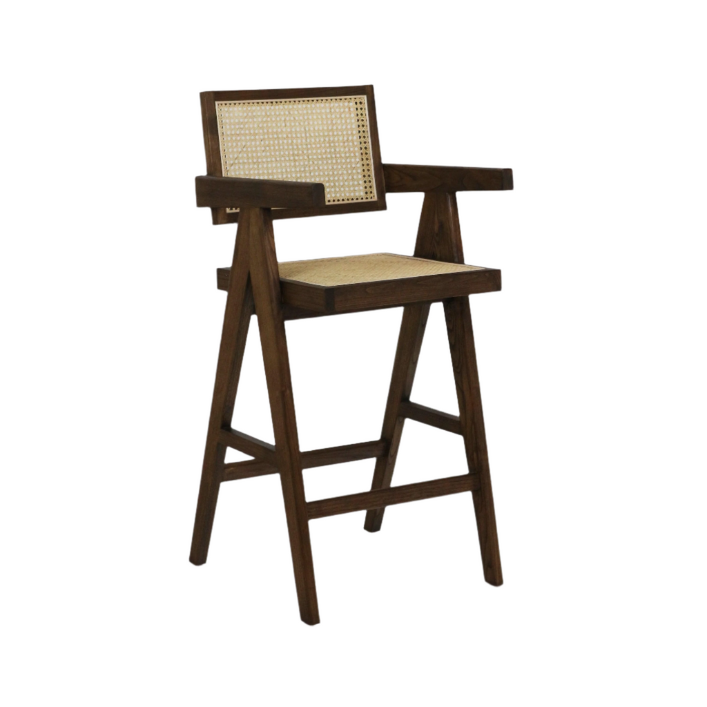 Mid-century modern natural wood bar stool with woven rattan seat and cane back, A-frame legs, footrest and broad wooden armrests.