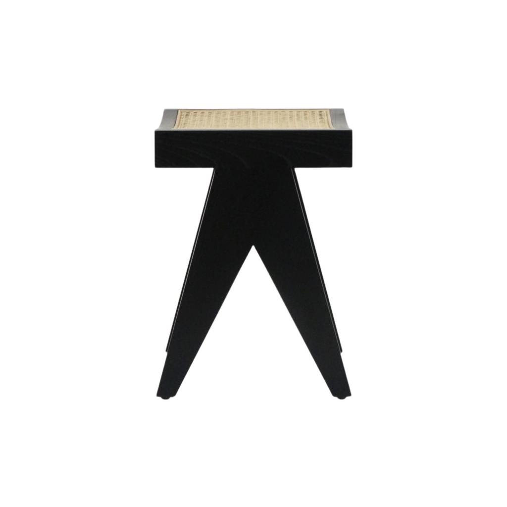 Front view of a low mid-century modern footstool with a black solid wood A-frame base and a woven natural cane seat top.