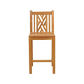Armless teak outdoor bar stool in a natural finish with a slatted seat, geometric lattice backrest, square legs and a front footrest, photographed against a white background.