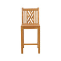 Armless teak outdoor bar stool in a natural finish with a slatted seat, geometric lattice backrest, square legs and a front footrest, photographed against a white background.
