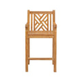 Front-facing natural teak outdoor bar stool with armrests, slatted seat, geometric lattice back and built-in footrest, coastal solid-wood construction in a warm teak finish.