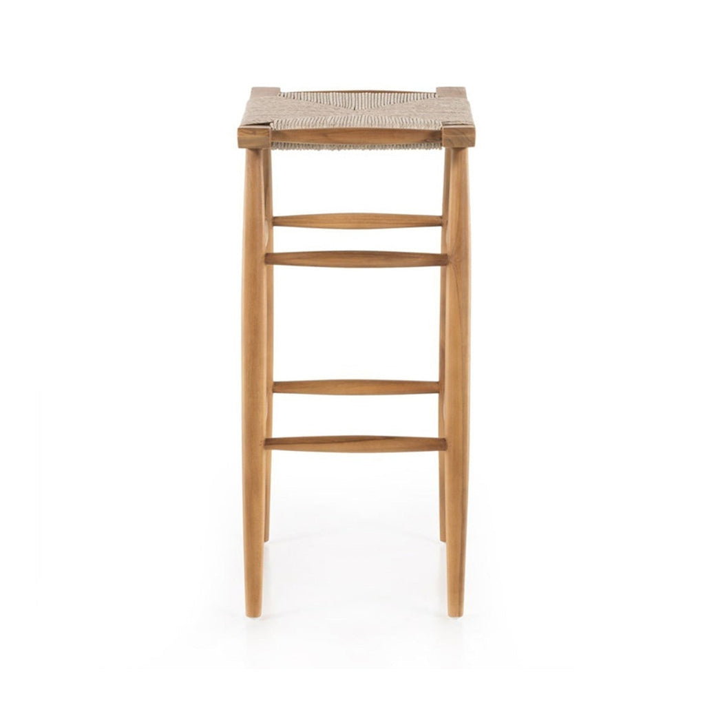 Front view of a backless teak outdoor bar stool with a woven natural-fiber seat, tapered legs and three horizontal footrest stretchers in a natural teak finish, coastal Scandinavian style.