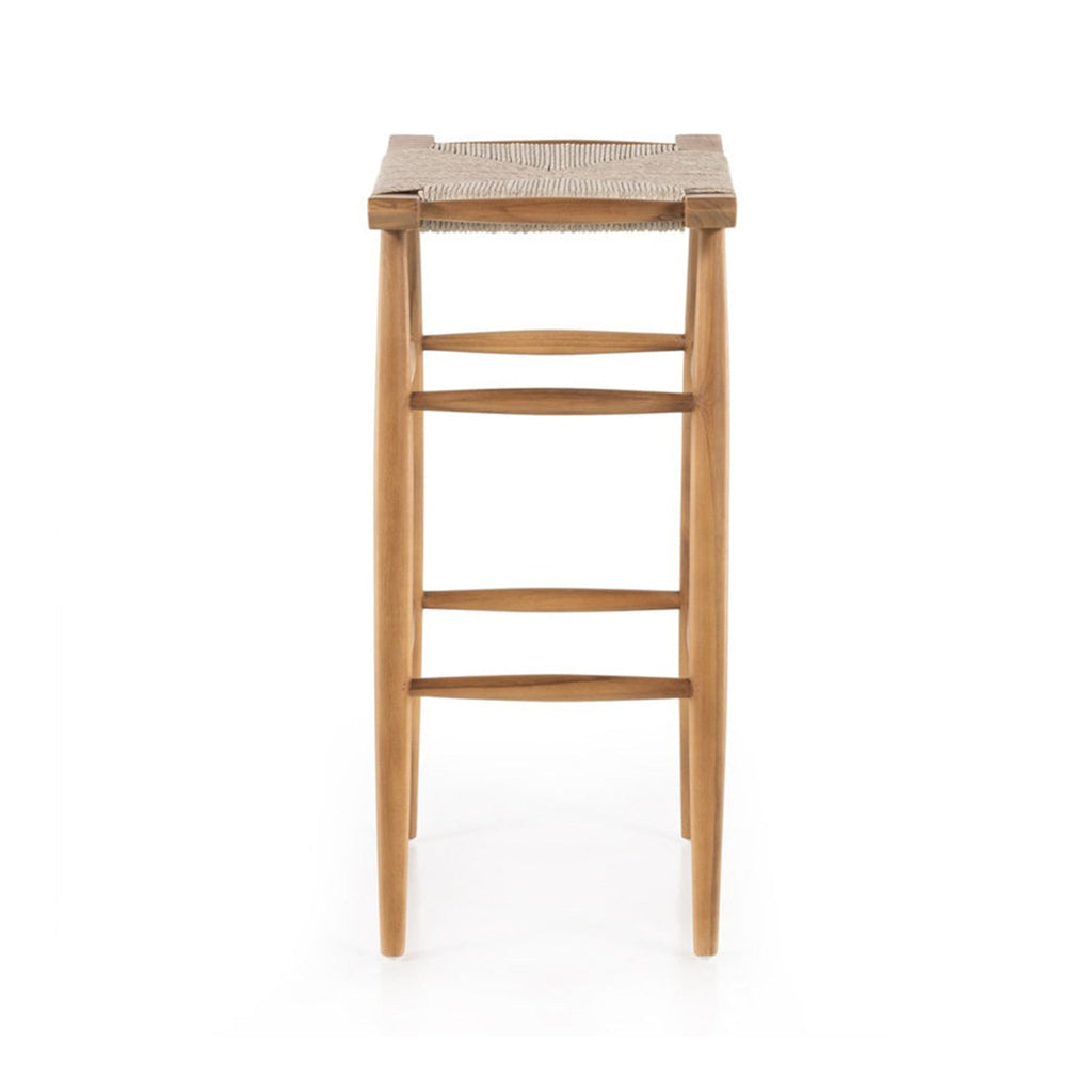 Front view of a backless teak outdoor bar stool with a woven natural-fiber seat, tapered legs and three horizontal footrest stretchers in a natural teak finish, coastal Scandinavian style.