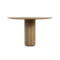 Round dining table in natural teak finish with a cylindrical pedestal base and slim solid-wood tabletop, styled in a mid-century modern aesthetic.