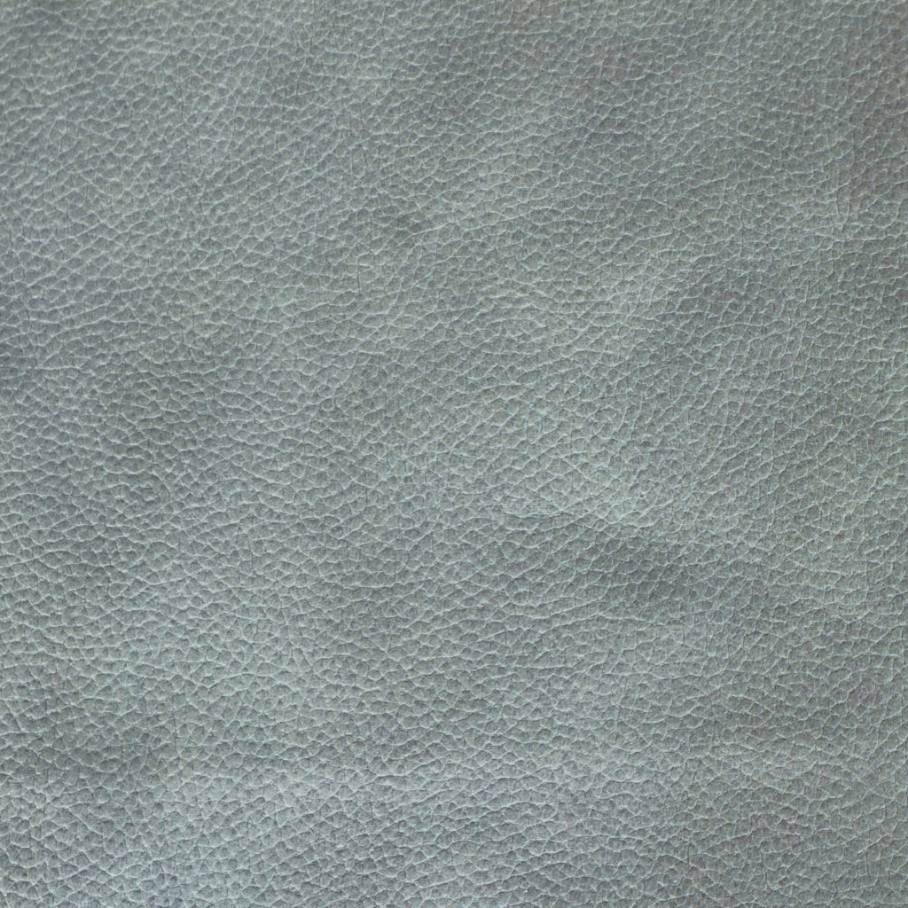 Close-up of blue faux leather upholstery showing a pebbled grain texture, suitable for a dining chair seat.