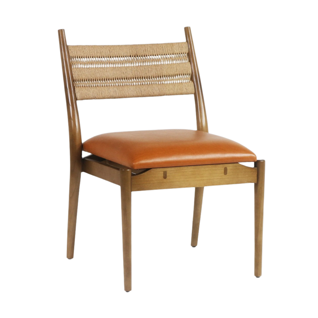 Armless side chair with a warm cognac faux leather seat, natural woven rope back and tapered light-wood frame, styled in a coastal-contemporary modern design.