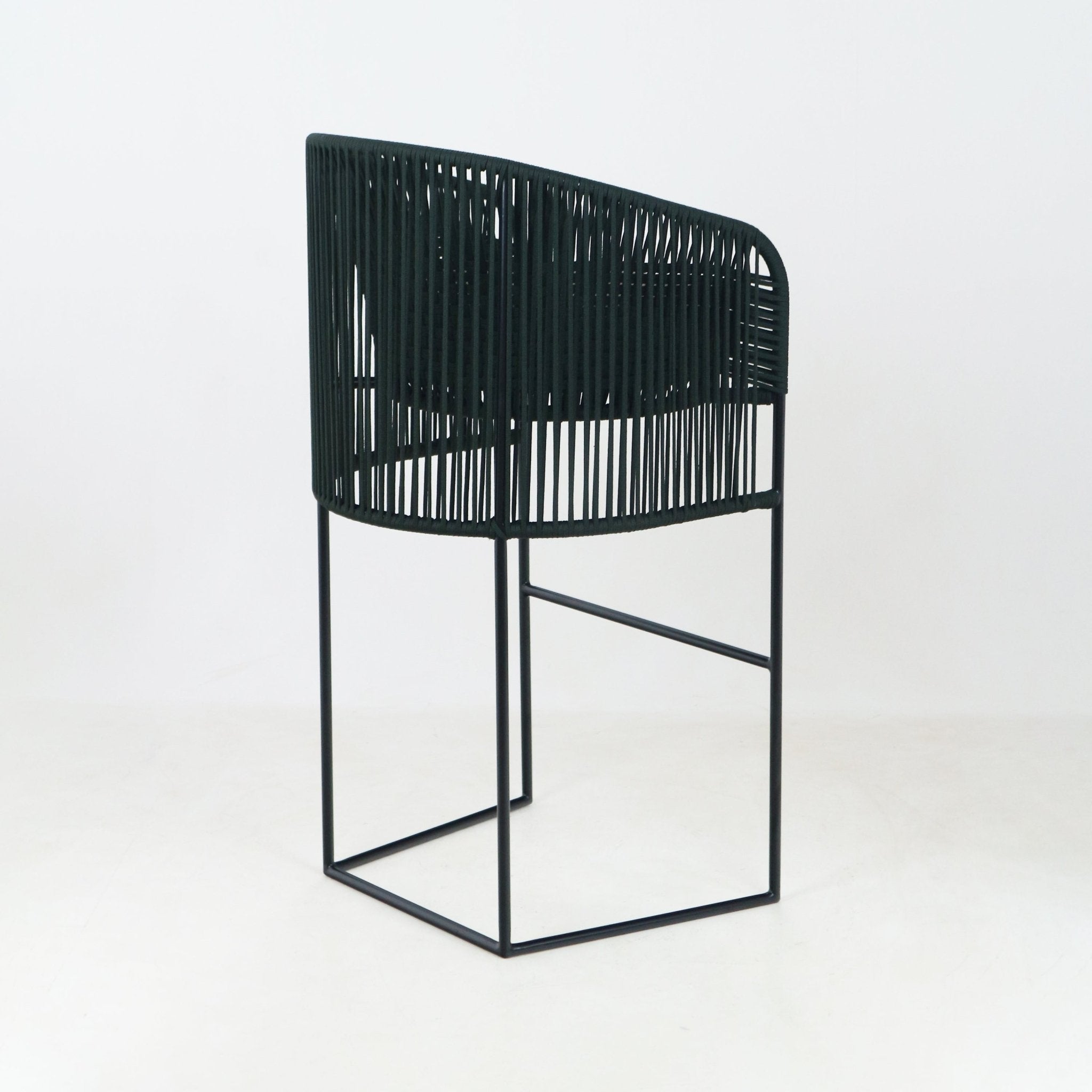 Deep green woven-rope outdoor counter bar stool with a curved open back and slim black metal sled base, coastal-style seating for patios or kitchen counters.