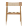 Front view of a natural teak outdoor dining chair with slatted wooden seat, tapered legs, slim arms and a beige woven rope back panel in a coastal mid-century modern style.
