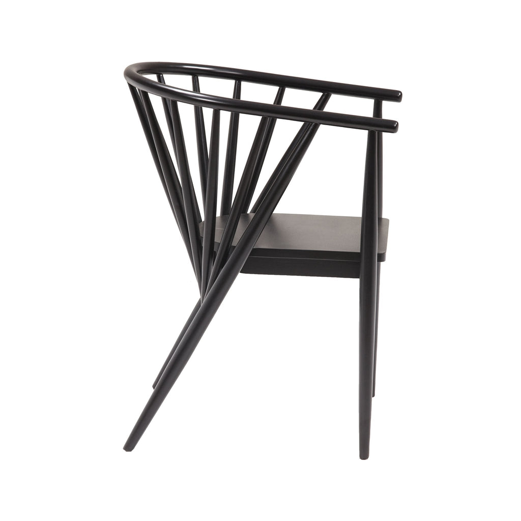 Side view of a mid-century modern solid wood dining chair in black gloss finish with a curved top rail, angled spindle back and tapered legs.
