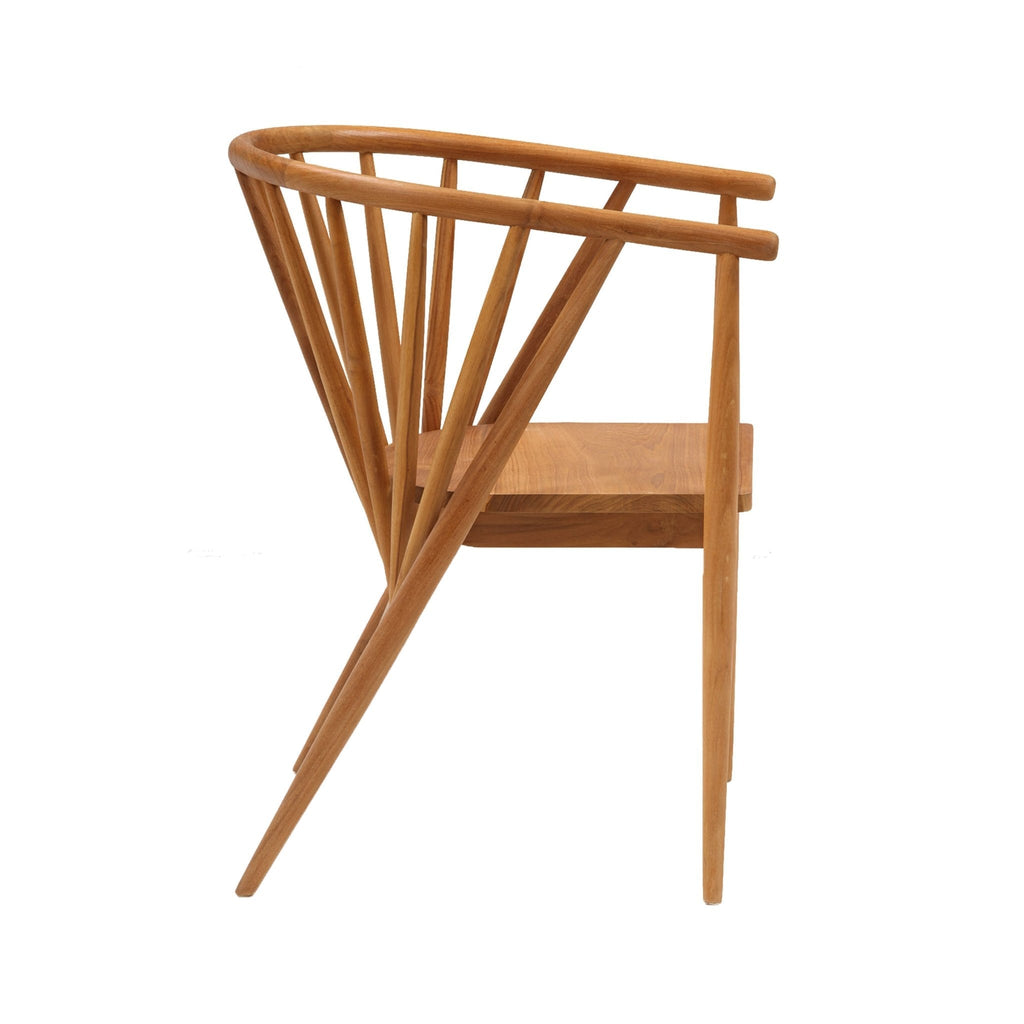 Side profile of a mid century modern teak dining chair with a curved spindle back and integrated armrest, solid wood seat and angled legs in a natural teak finish.