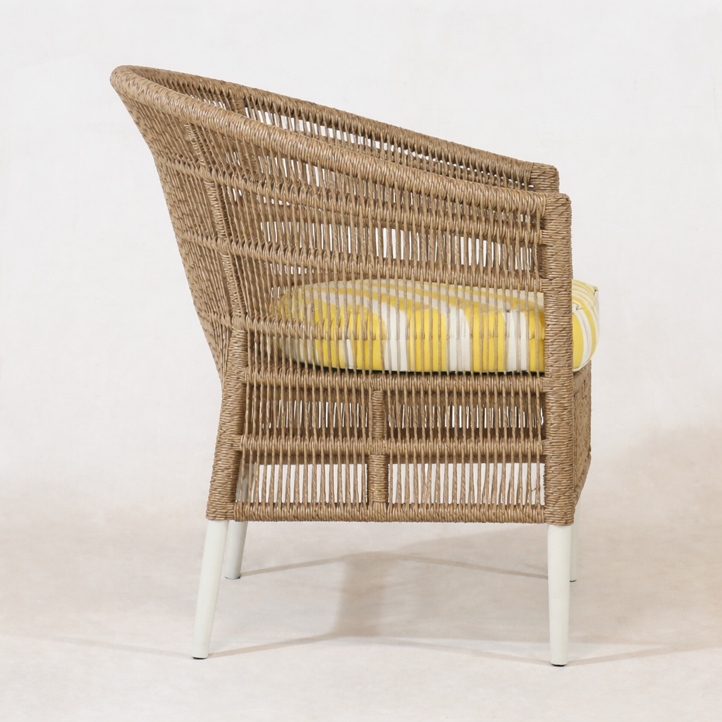 Side view of the Sirena Wicker chair with a yellow cushion on a white background by nuema.com