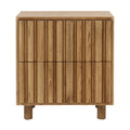 Front view of a Scandinavian modern solid wood nightstand in natural blonde finish with two fluted drawer fronts, subtle recessed seams between drawers and short round wooden legs.