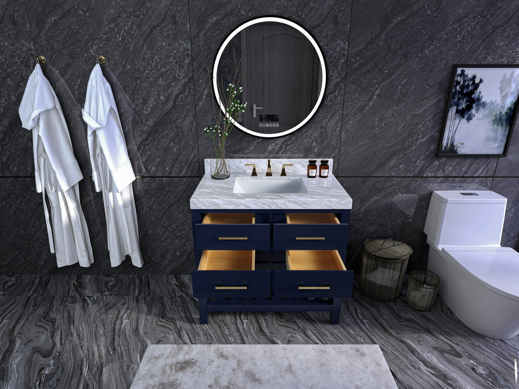 36-inch modern solid wood single-sink vanity with a stone marble top, navy painted freestanding base, four open drawers with brass pulls, rectangular undermount ceramic sink and brass faucet, set against dark stone tile with round mirror.