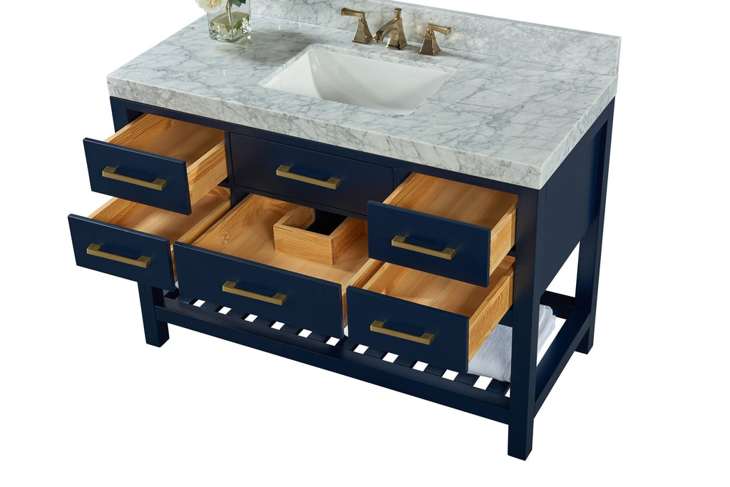 Contemporary solid wood bathroom vanity with a stone marble top and integrated white ceramic undermount sink, brushed brass faucet and drawer pulls, six drawers with natural wood interiors and a slatted open shelf.