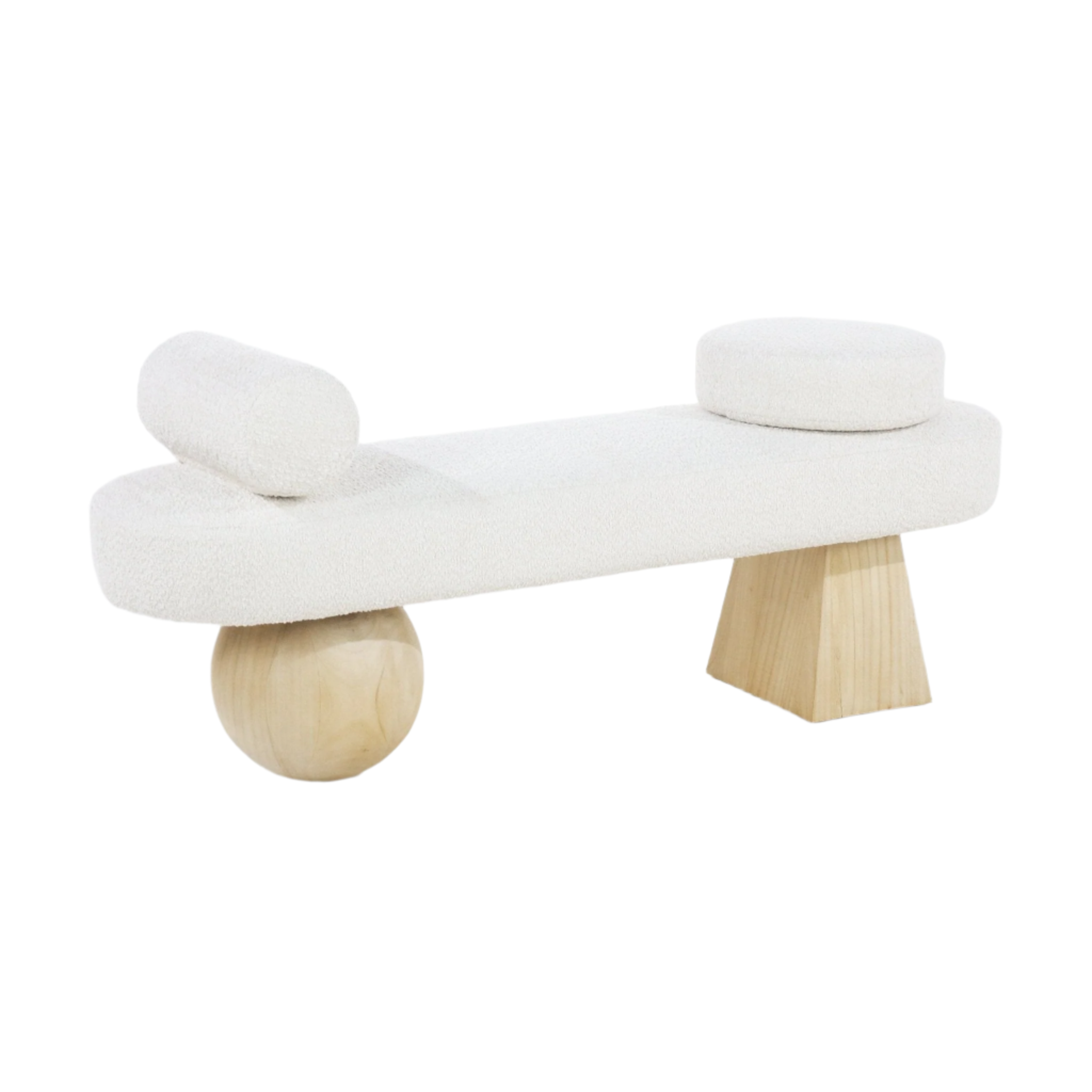 Backless end-of-bed bench upholstered in cream boucle fabric with sculptural natural wood legs, a round wooden ball leg on one side and a tapered block leg on the other, plus round and bolster cushions for a modern coastal look.