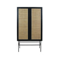 Tall modern wardrobe with a black wooden frame, twin natural cane rattan door panels and slim black metal legs, shown front-on against a white background.