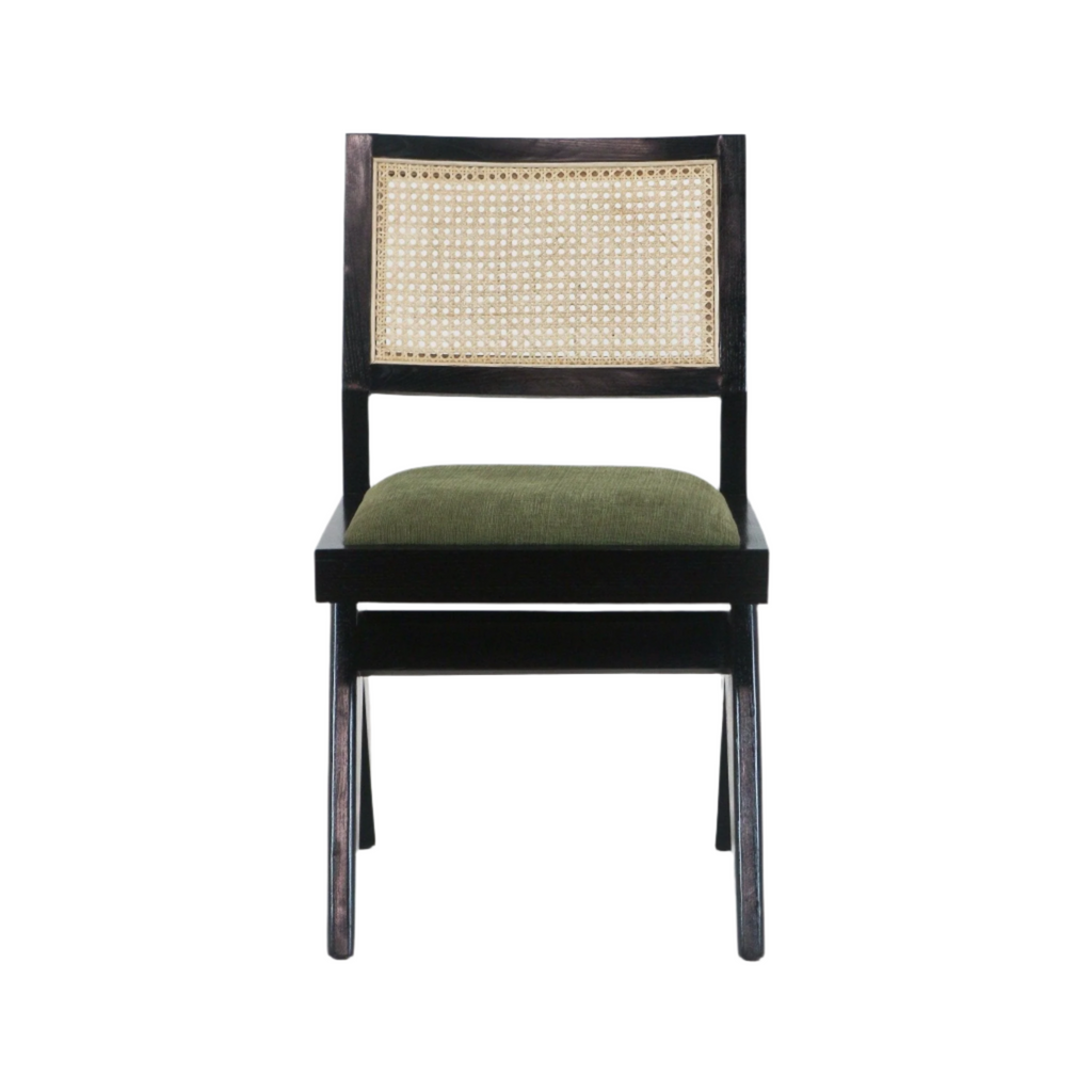 Front view of an armless dining chair with a black solid wood frame, natural cane woven backrest and green upholstered seat in a mid-century modern style.