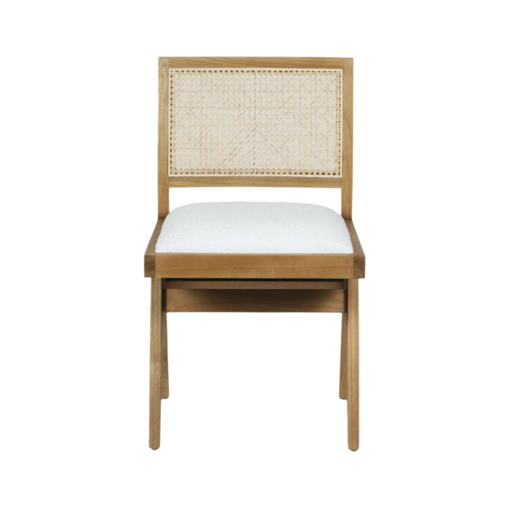 Front view of an armless dining side chair with a natural blonde solid wood frame, woven cane backrest and cream boucle upholstered seat in a mid-century modern style.