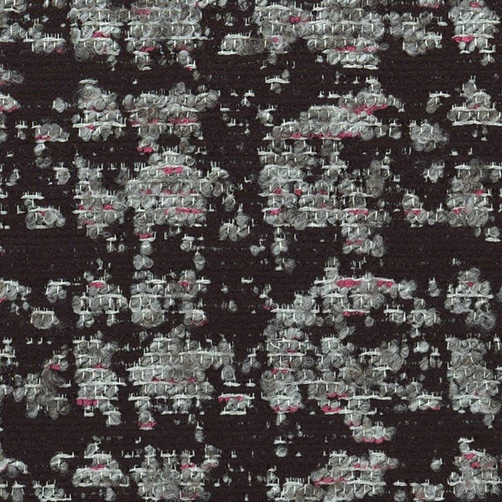 Close-up of viscose-blend black upholstery fabric showing textured gray and white woven loops with small pink accent threads in an irregular speckled pattern.