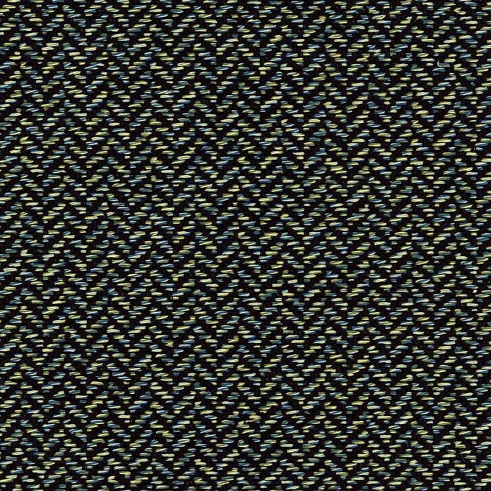 Close-up of woven upholstery fabric (38% rayon, 62% polyester) on a dark neutral ground with lime-green and teal flecks forming a subtle herringbone chevron pattern, a modern contemporary texture for sofas and office seating.