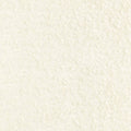 Close-up of cream boucle woven upholstery fabric for sofas, showing a soft nubby texture; 24% wool, 11% linen, 15% viscose, 40% acrylic and 10% polyester blend.