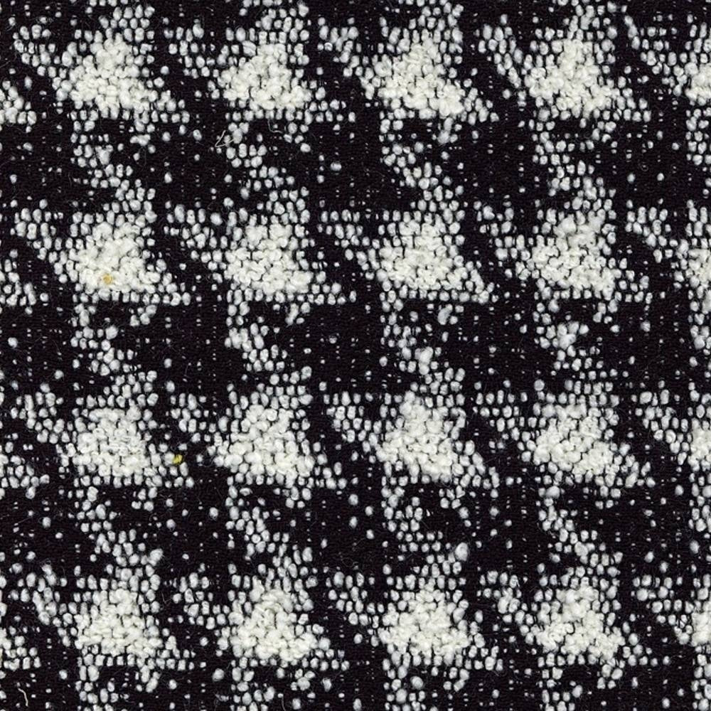 Close-up of black and white boucle upholstery fabric with a textured, houndstooth-like pattern in a wool-acrylic-cotton-polyester blend, shown as a swatch for sofa upholstery.