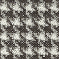 Close-up of black-and-white boucle upholstery fabric showing a textured small-scale houndstooth pattern with looped yarns and woven base; 25% wool, 44% acrylic, 21% cotton, 10% polyester blend.