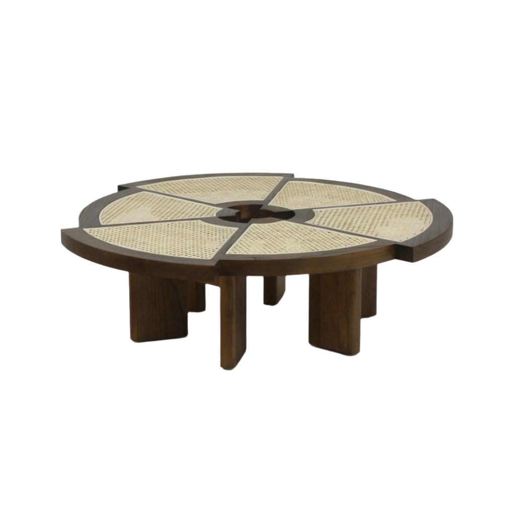 Low round coffee table in medium brown wood with natural cane inlay arranged in six radial panels around a small central opening, resting on chunky segmented wooden legs for a modern midcentury look.