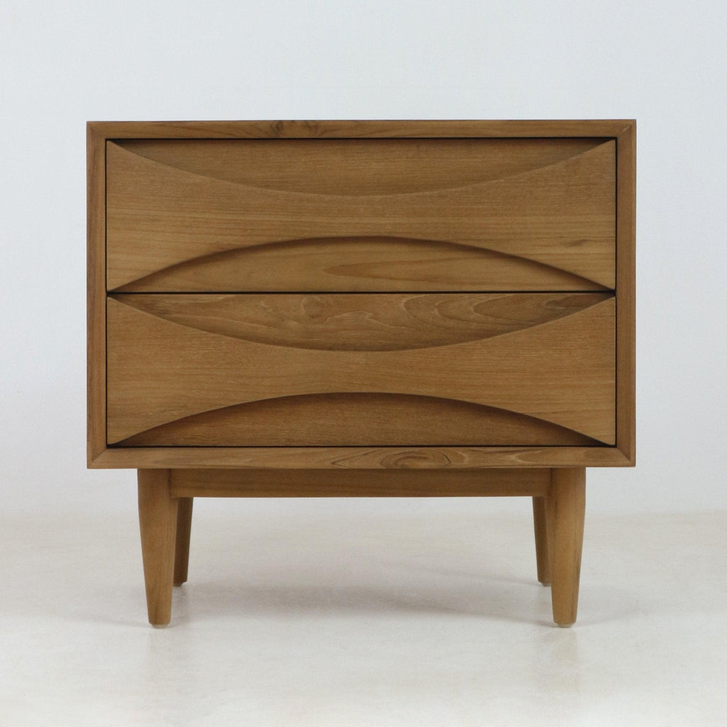Natural teak two-drawer nightstand in mid-century Scandinavian style with carved recessed drawer pulls, tapered legs and warm wood grain finish shown on a pale neutral background.