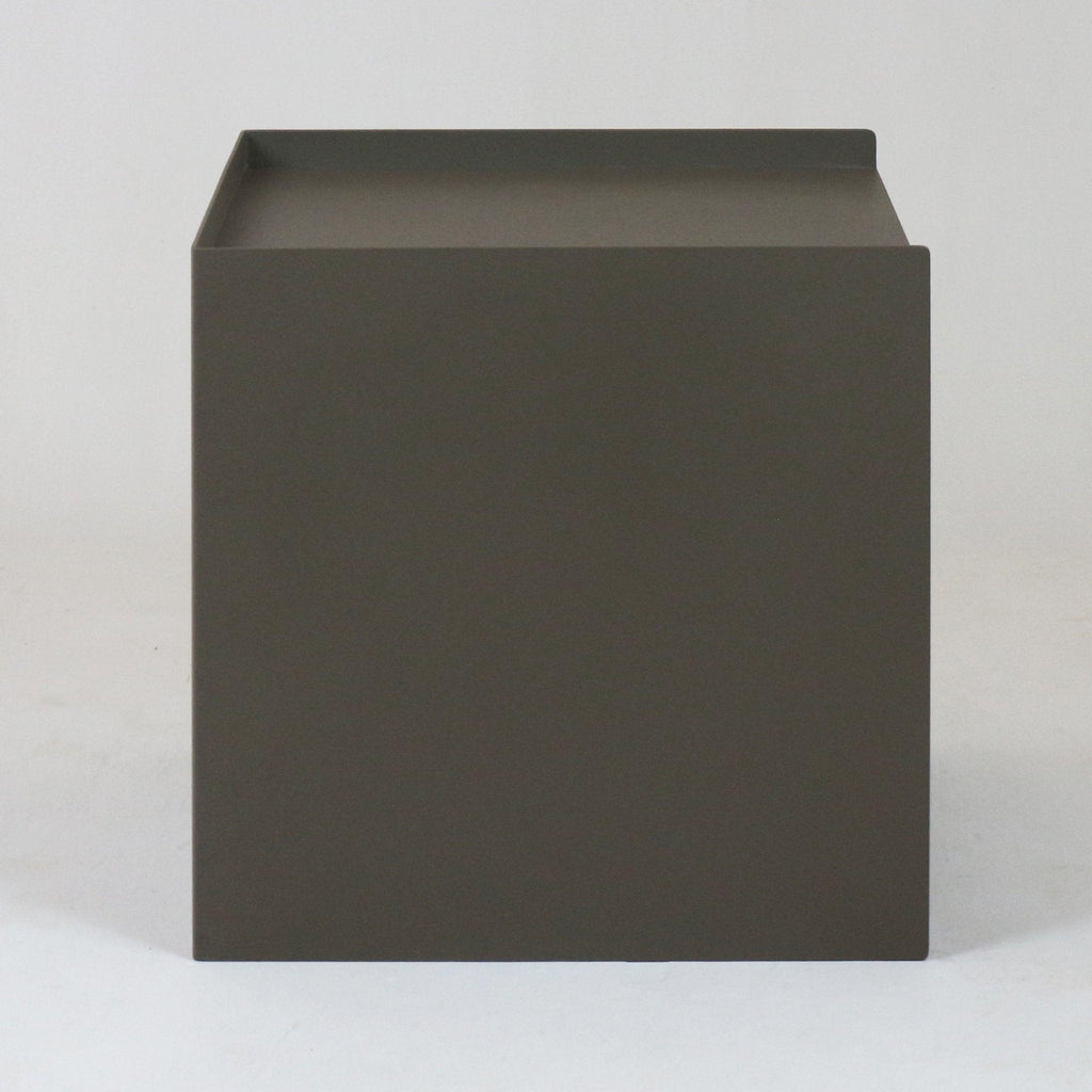 Minimal modern matte-gray nightstand with a cube-shaped metal body and raised lip tray top, finished in a brushed-steel look, photographed on a neutral studio background.