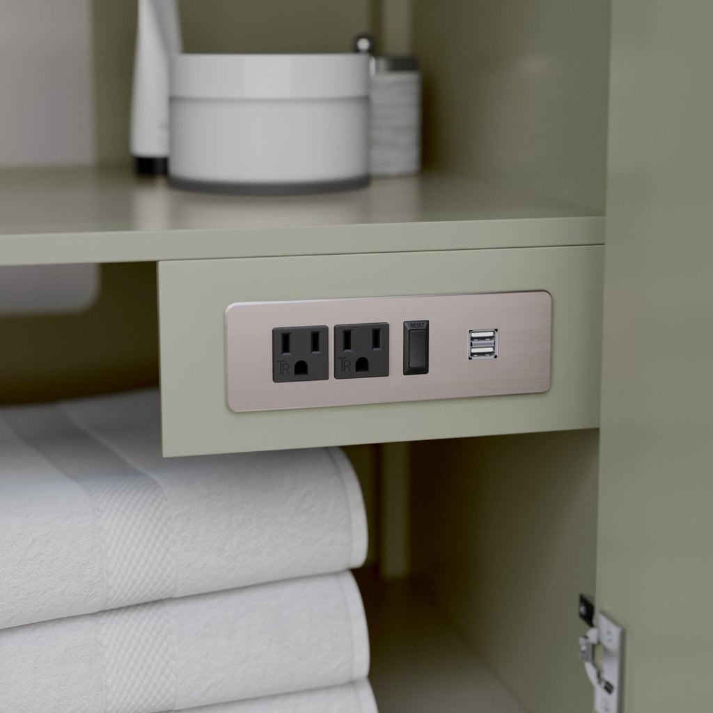 Close-up of a modern stone-colored solid wood vanity interior showing a brushed metal outlet panel with two electrical sockets, a GFCI reset switch and dual USB ports above neatly folded white towels.