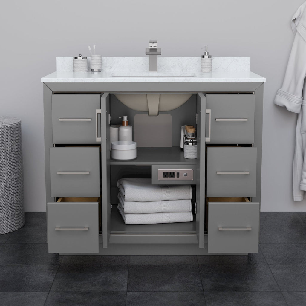 42-inch modern solid wood bathroom vanity in stone gray with a marble-look stone top and undermount ceramic sink, brushed-nickel handles, open center cabinet with folded towels and toiletries plus built-in power outlet.