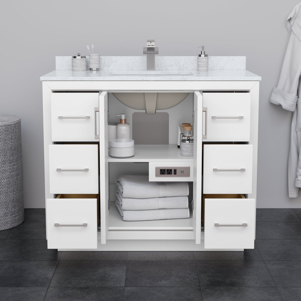 Front view of a 42-inch modern white solid wood bathroom vanity with a stone top and single integrated sink, six drawers flanking an open center cabinet with folded towels and a built-in outlet, brushed-nickel handles.