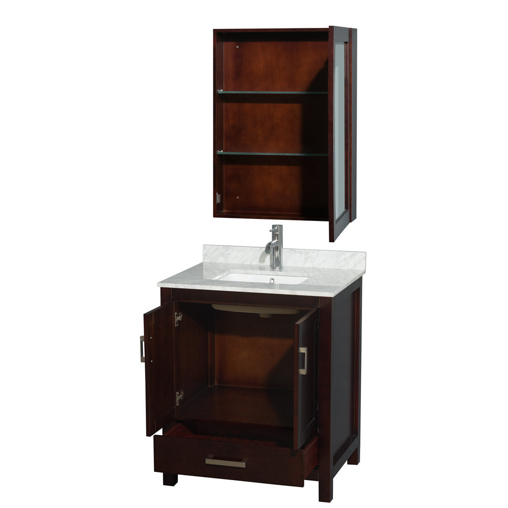Modern single-sink bathroom vanity in dark solid wood with a white ceramic sink and stone countertop; lower cabinet doors and front drawer open to reveal storage, with a matching wall cabinet above featuring glass shelves.