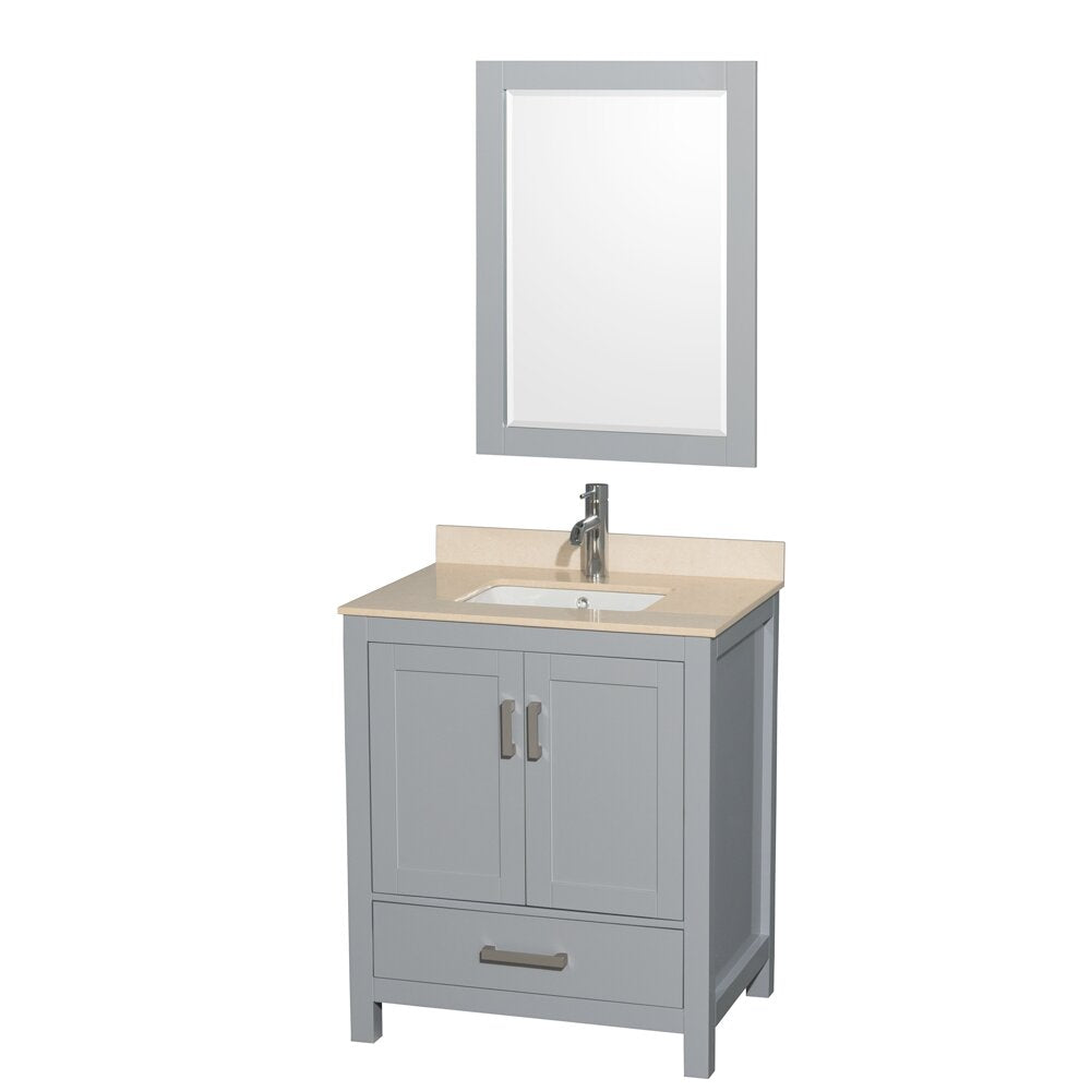 Freestanding modern bathroom vanity in gray solid wood with a beige stone countertop, integrated white ceramic sink, single-handle chrome faucet, two shaker-style cabinet doors, bottom drawer and matching rectangular mirror above.