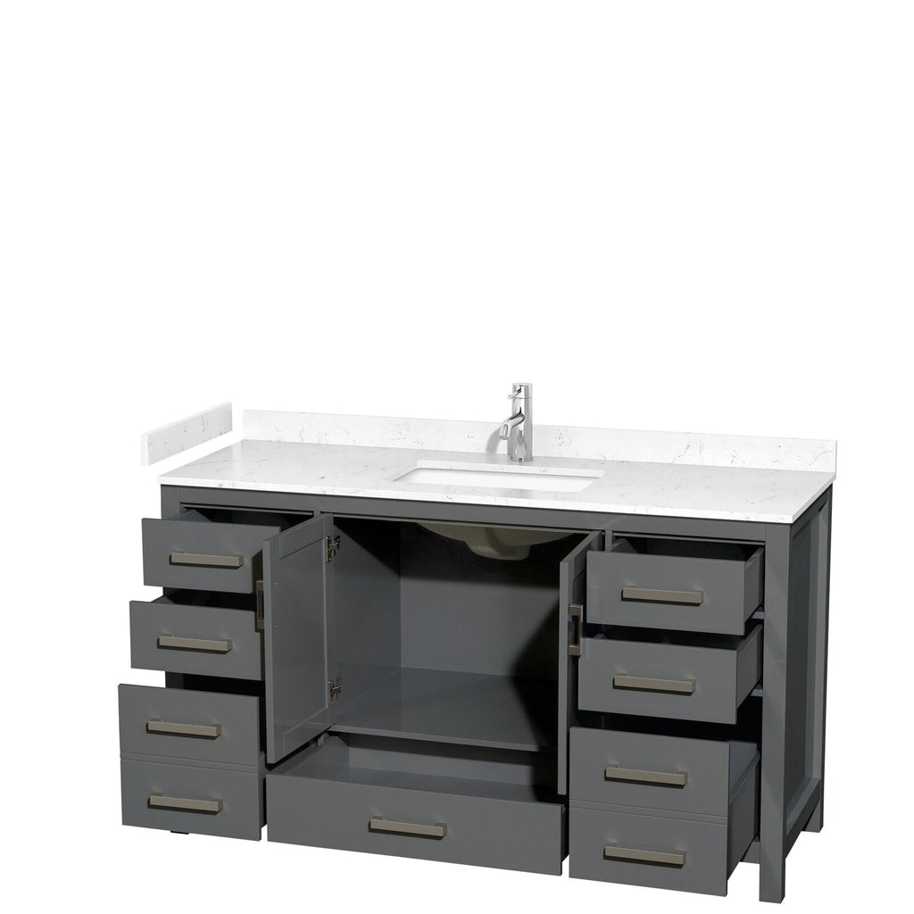 Freestanding modern gray wood bathroom vanity with white stone countertop and integrated single sink, chrome faucet, open center cabinet showing plumbing and shelf, and multiple drawers with brushed metal handles.